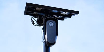 A Flock camera mounted on a light pole